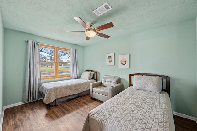 126 Lakeview Dr, Buchanan Dam, TX 78609 - bedroom with visible vents, baseboards, a textured ceiling, and wood finished floors