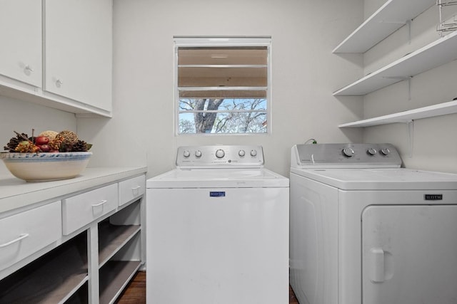 clothes washing area with cabinet space and washing machine and dryer