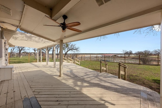 wooden deck with a fenced backyard, visible vents, a lawn, and a ceiling fan