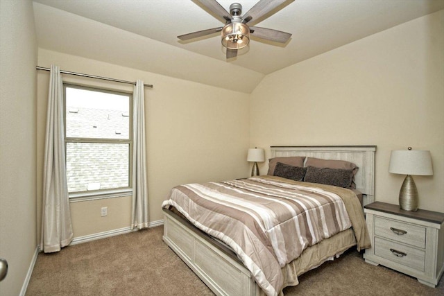 carpeted bedroom featuring baseboards, lofted ceiling, and a ceiling fan