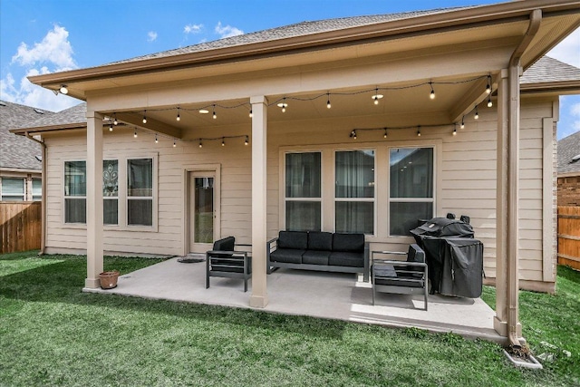 back of property with outdoor lounge area, a patio area, fence, and a lawn