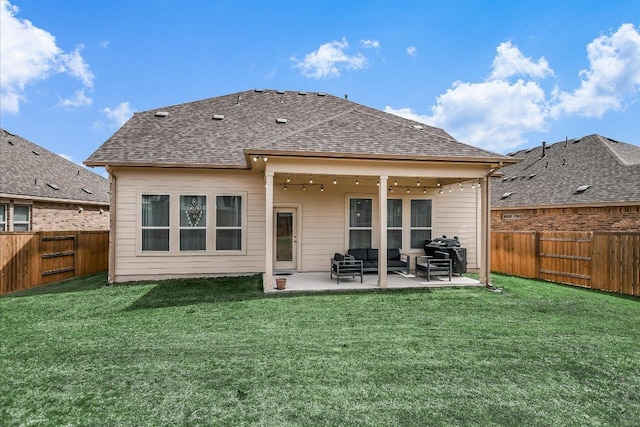 back of property featuring a patio, a yard, a fenced backyard, and a shingled roof