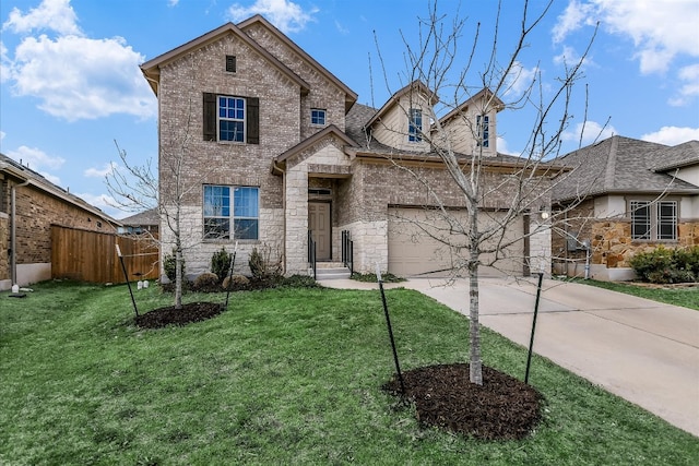 view of front of home featuring brick siding, a front lawn, fence, driveway, and an attached garage