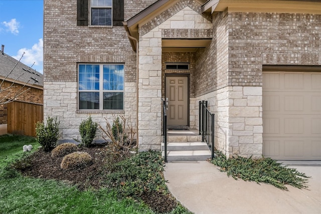 property entrance with stone siding and an attached garage