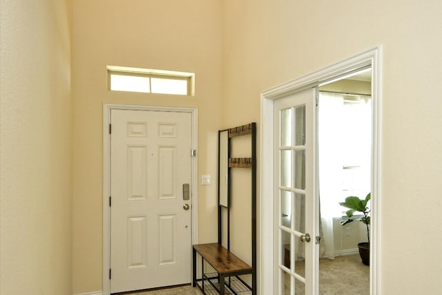 entrance foyer featuring light colored carpet