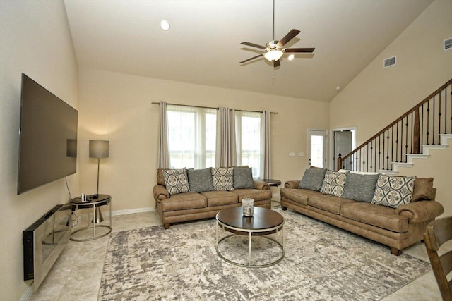 tiled living room featuring visible vents, baseboards, high vaulted ceiling, and a ceiling fan