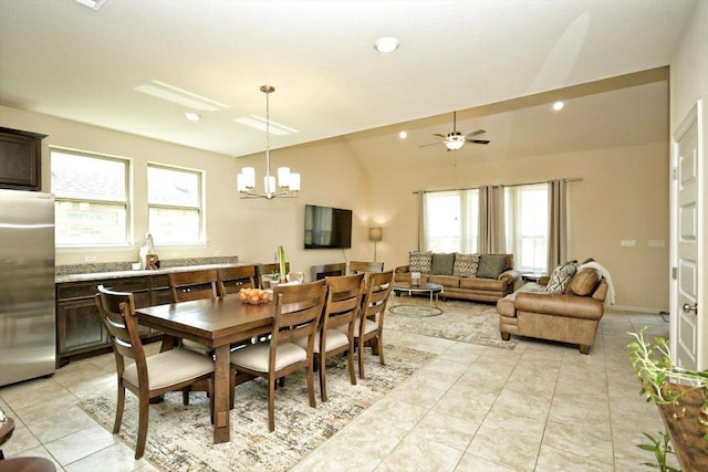 dining room with light tile patterned floors, lofted ceiling, recessed lighting, and ceiling fan with notable chandelier