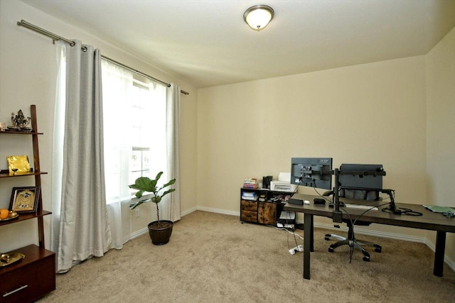 home office with baseboards, plenty of natural light, and carpet floors