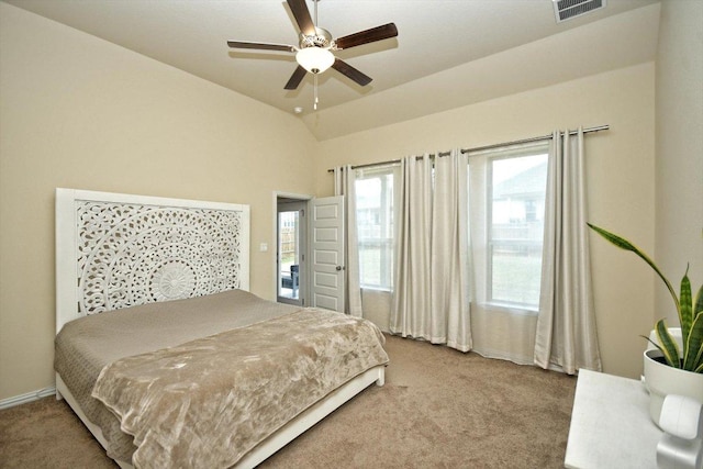 carpeted bedroom featuring visible vents, baseboards, ceiling fan, and vaulted ceiling