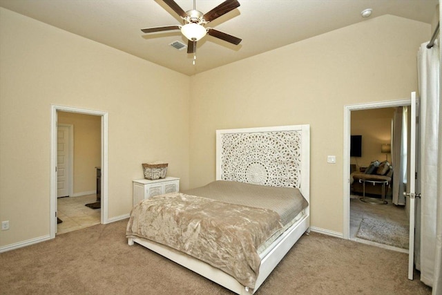 carpeted bedroom with visible vents, baseboards, lofted ceiling, and a ceiling fan