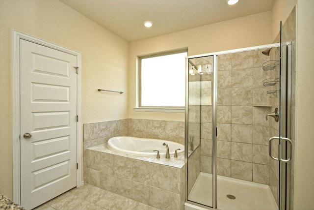 full bathroom with a stall shower, a bath, and recessed lighting