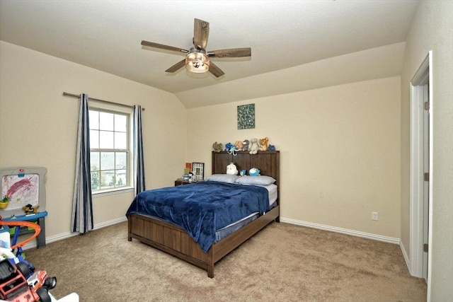 bedroom with ceiling fan, vaulted ceiling, baseboards, and light carpet