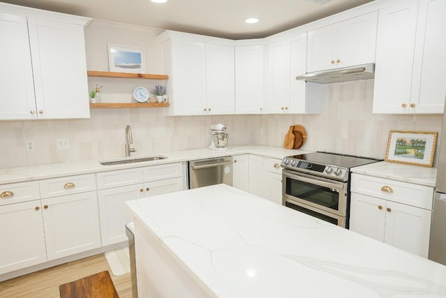 kitchen featuring a sink, under cabinet range hood, appliances with stainless steel finishes, decorative backsplash, and recessed lighting