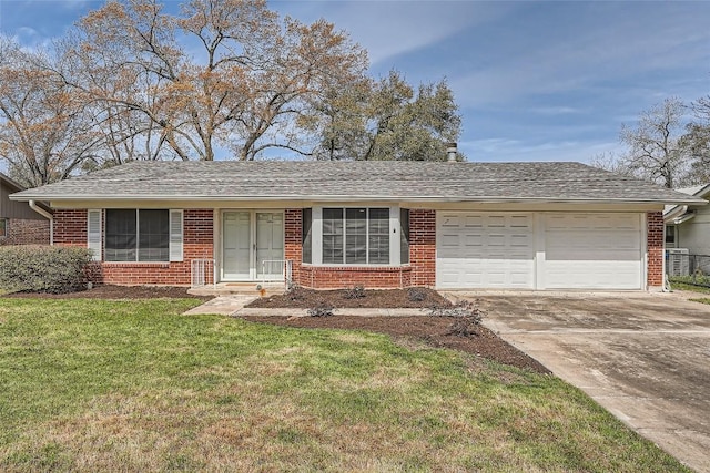 single story home with brick siding, a front yard, concrete driveway, and an attached garage