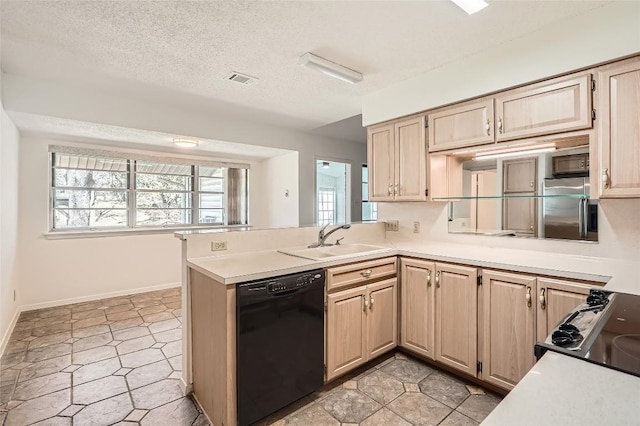 kitchen featuring a textured ceiling, black appliances, light countertops, and a sink