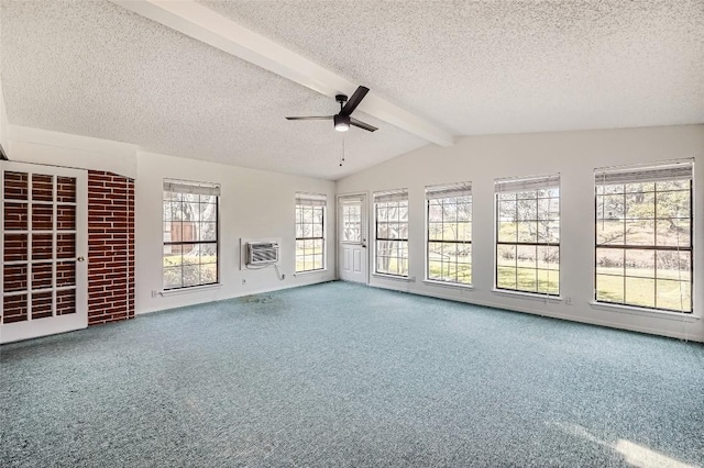 unfurnished living room featuring a ceiling fan, carpet floors, lofted ceiling with beams, an AC wall unit, and a textured ceiling