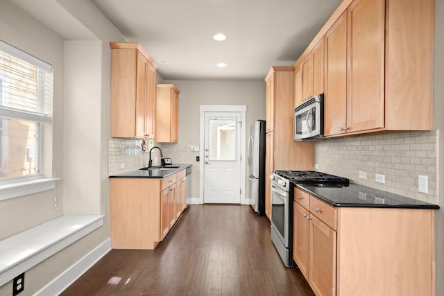 1601 Miriam Ave Unit 103, Austin, TX 78702 - kitchen featuring appliances with stainless steel finishes, light brown cabinetry, dark wood-type flooring, and recessed lighting