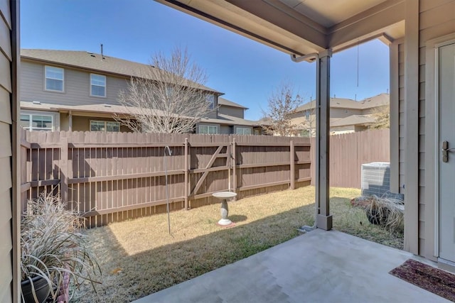 view of yard with a patio, central air condition unit, and a fenced backyard