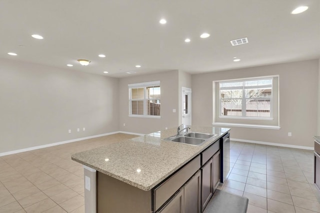 kitchen featuring visible vents, plenty of natural light, dishwasher, and a sink