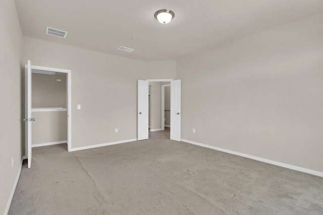 unfurnished bedroom featuring visible vents, baseboards, and carpet