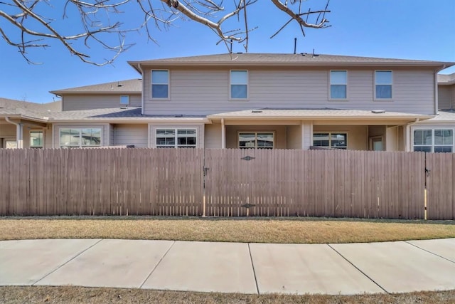 townhome / multi-family property with a fenced front yard