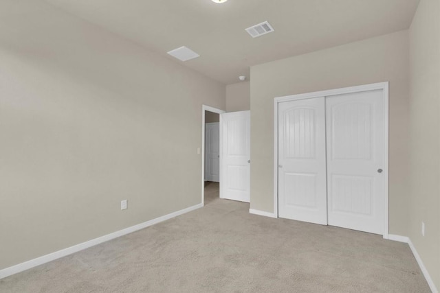 unfurnished bedroom with visible vents, baseboards, a closet, and carpet flooring