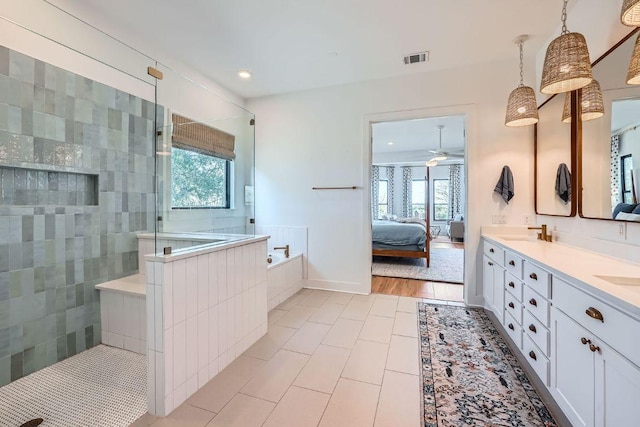 bathroom featuring ensuite bath, a walk in shower, visible vents, and a wealth of natural light