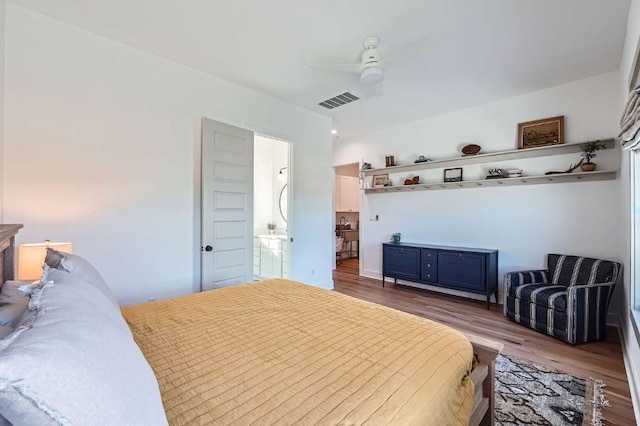 bedroom with ceiling fan, visible vents, and wood finished floors