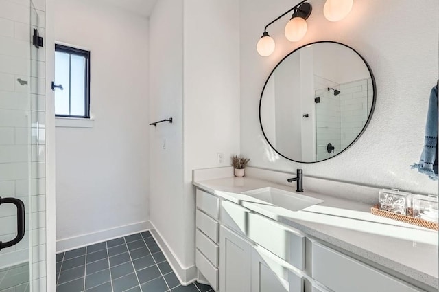 bathroom with tile patterned floors, baseboards, vanity, and a shower stall