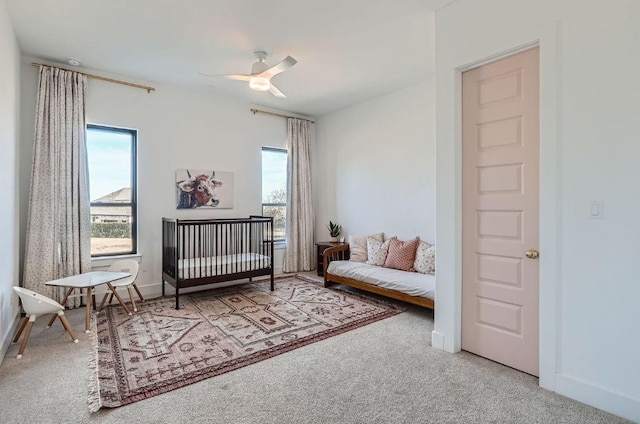 carpeted bedroom with baseboards and ceiling fan