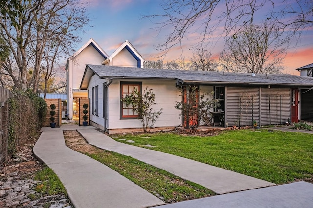 view of front of house with a front lawn and fence