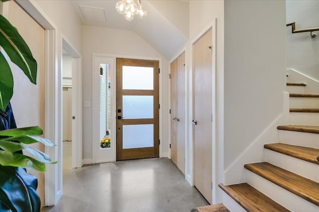 entryway with visible vents, stairway, concrete floors, and vaulted ceiling