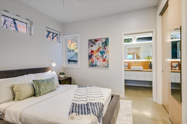 bedroom featuring multiple windows and ensuite bathroom