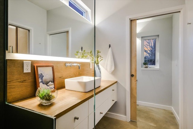 bathroom with baseboards and vanity