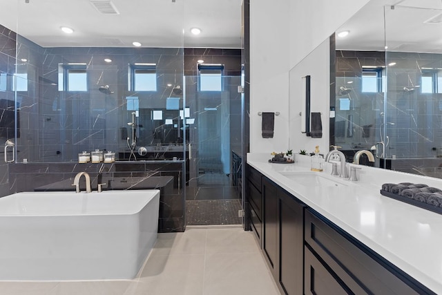 full bathroom with visible vents, a stall shower, tile patterned flooring, a freestanding bath, and vanity