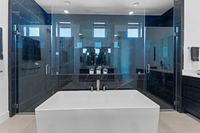 full bathroom featuring tile patterned floors, a stall shower, and vanity