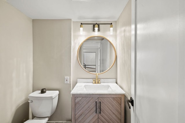 bathroom with toilet and vanity