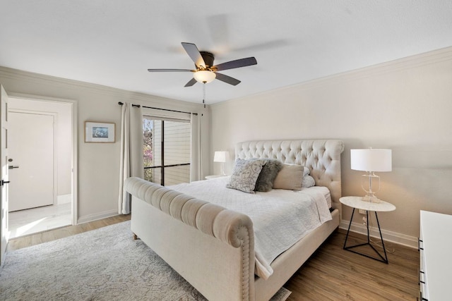 bedroom with a ceiling fan, crown molding, wood finished floors, and baseboards