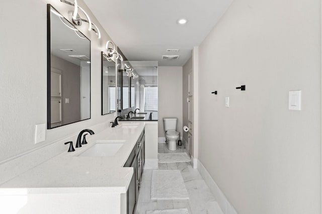 111 World Of Tennis Sq, Lakeway, TX 78738 - bathroom featuring double vanity, marble finish floors, and recessed lighting