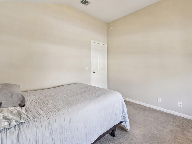 carpeted bedroom featuring vaulted ceiling, baseboards, and visible vents