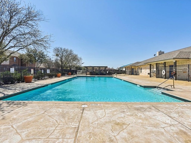 pool featuring a patio and fence