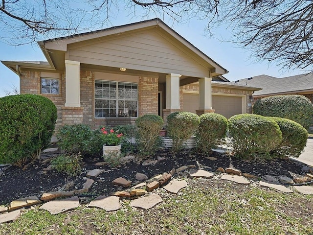 craftsman house with brick siding and a garage