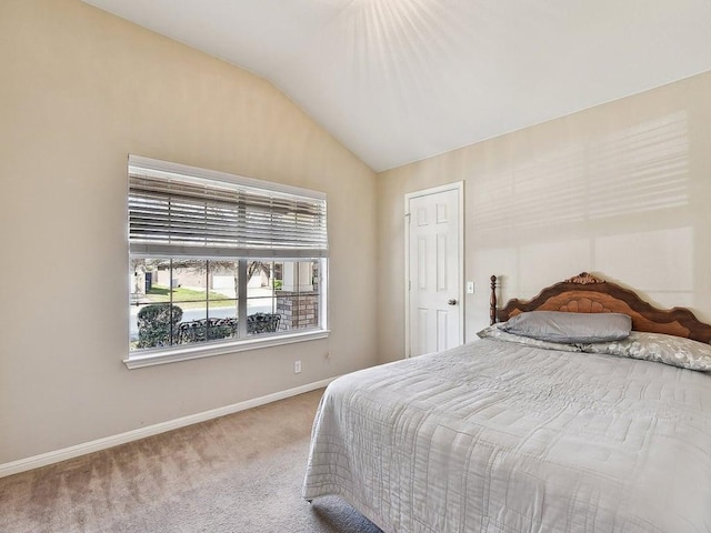 bedroom featuring baseboards, carpet floors, and vaulted ceiling