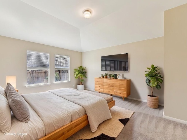 bedroom with vaulted ceiling and baseboards