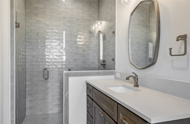 bathroom with a stall shower and vanity