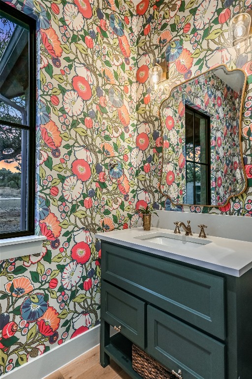 bathroom featuring wallpapered walls and vanity