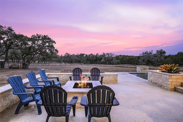 view of patio / terrace featuring an outdoor fire pit