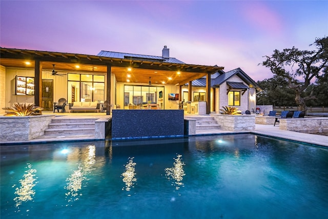 outdoor pool with outdoor dry bar, an outdoor living space, exterior kitchen, and a patio