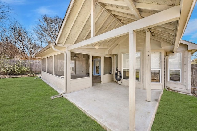 view of patio / terrace featuring fence and a sunroom