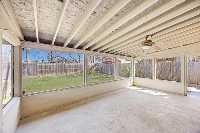 unfurnished sunroom with ceiling fan